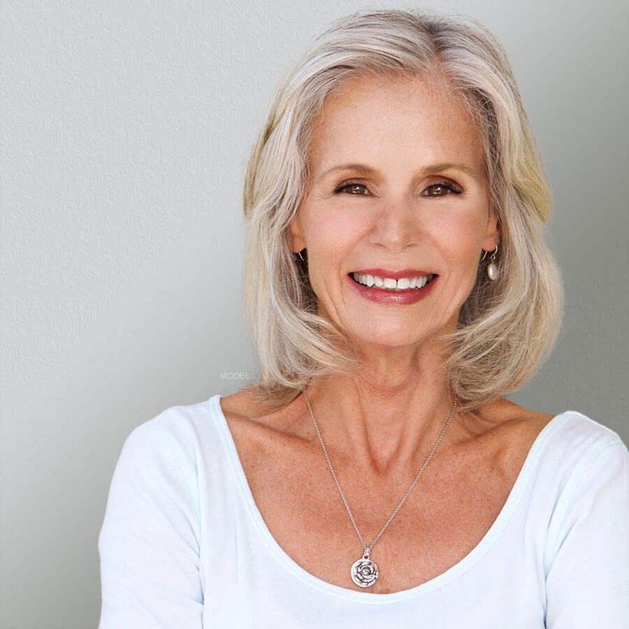 Woman smiling wearing white clothes