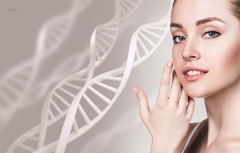 Woman caressing her face with DNA chains behind her. Stem cell concept. 